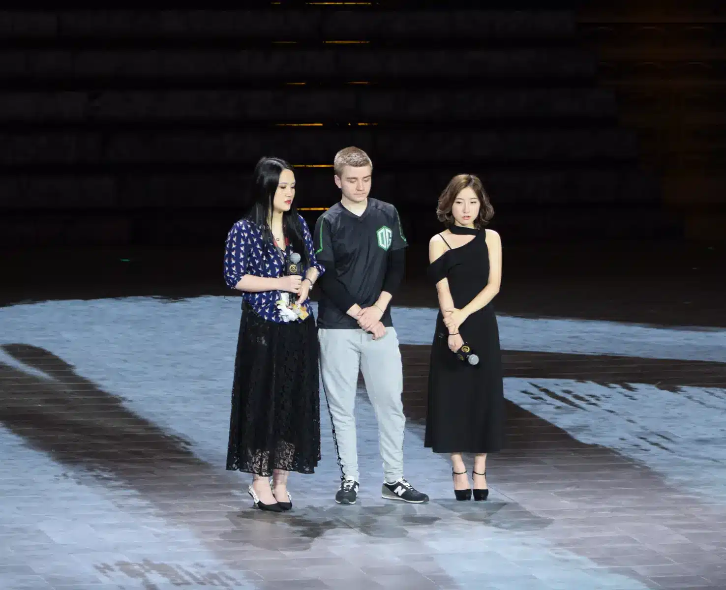 A member of the OG esports team standing on a stage during a winner's interview.