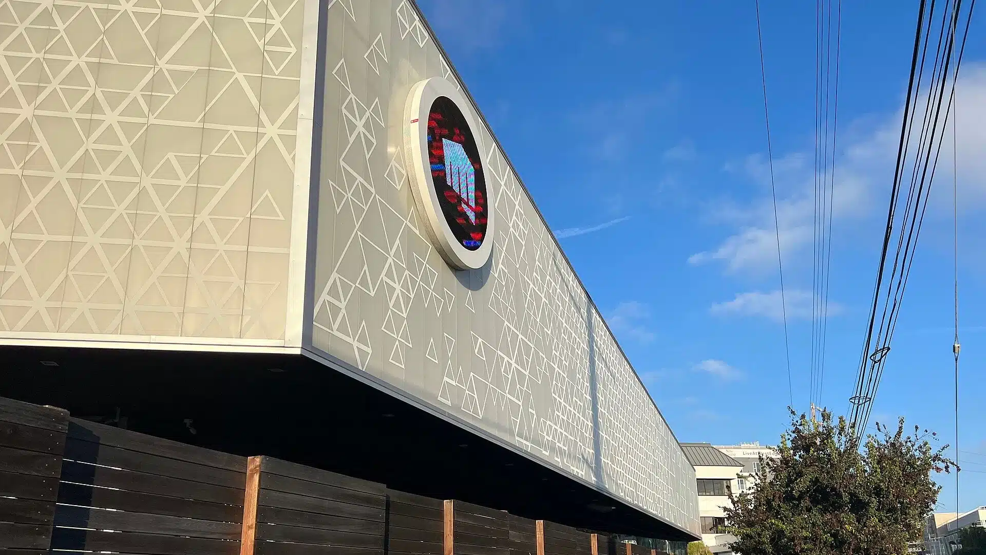 The exterior of the Riot Games headquarters featuring the company logo on the building facade.